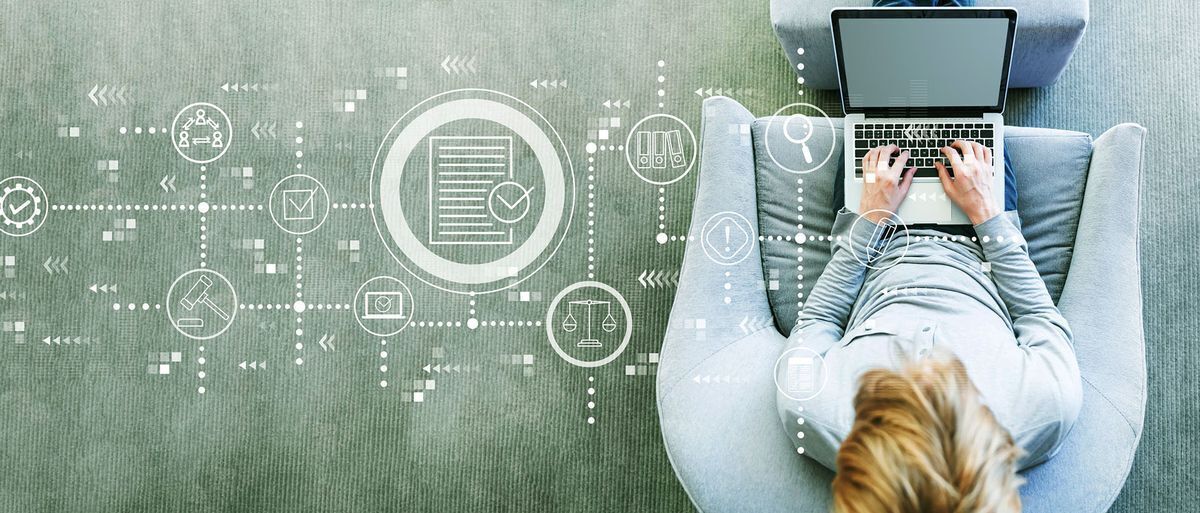 Employee sitting with laptop working on sustainability