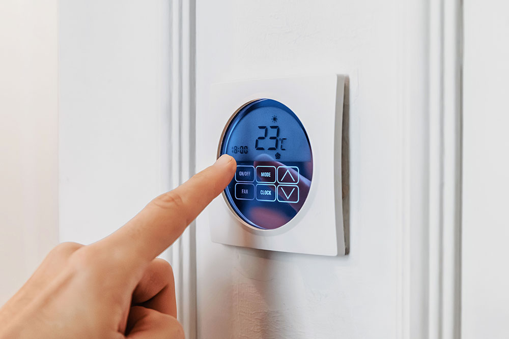 Wall thermostat is operated with a finger