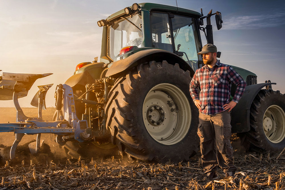 Man in front of tractor in a field